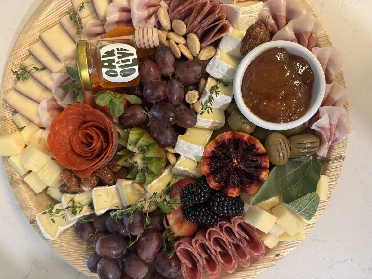 Classic artisan charcuterie board with branded honey jar