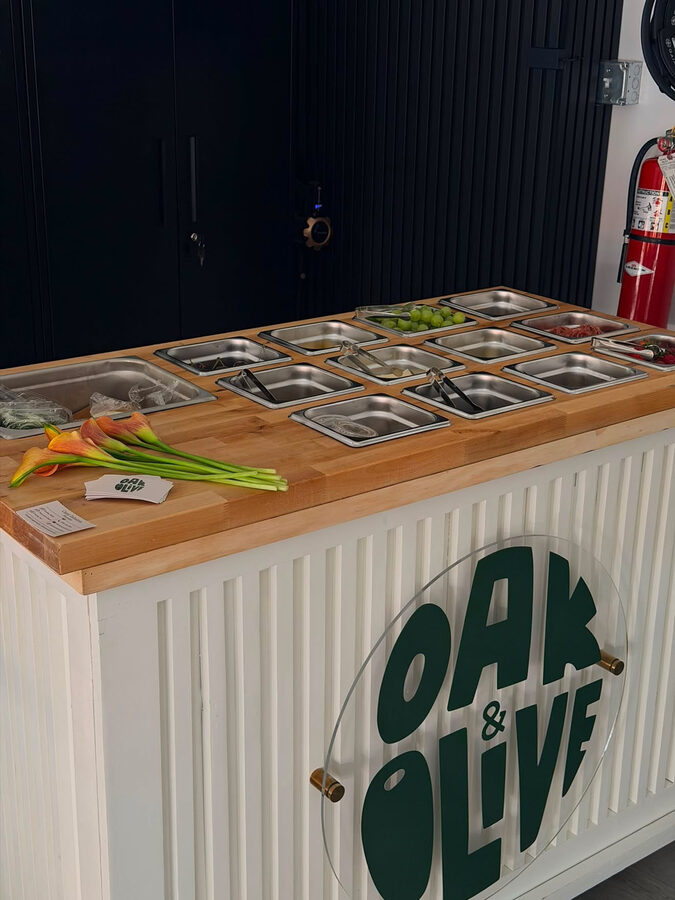 The Oak and Olive interactive charcuterie cart at an outdoor event